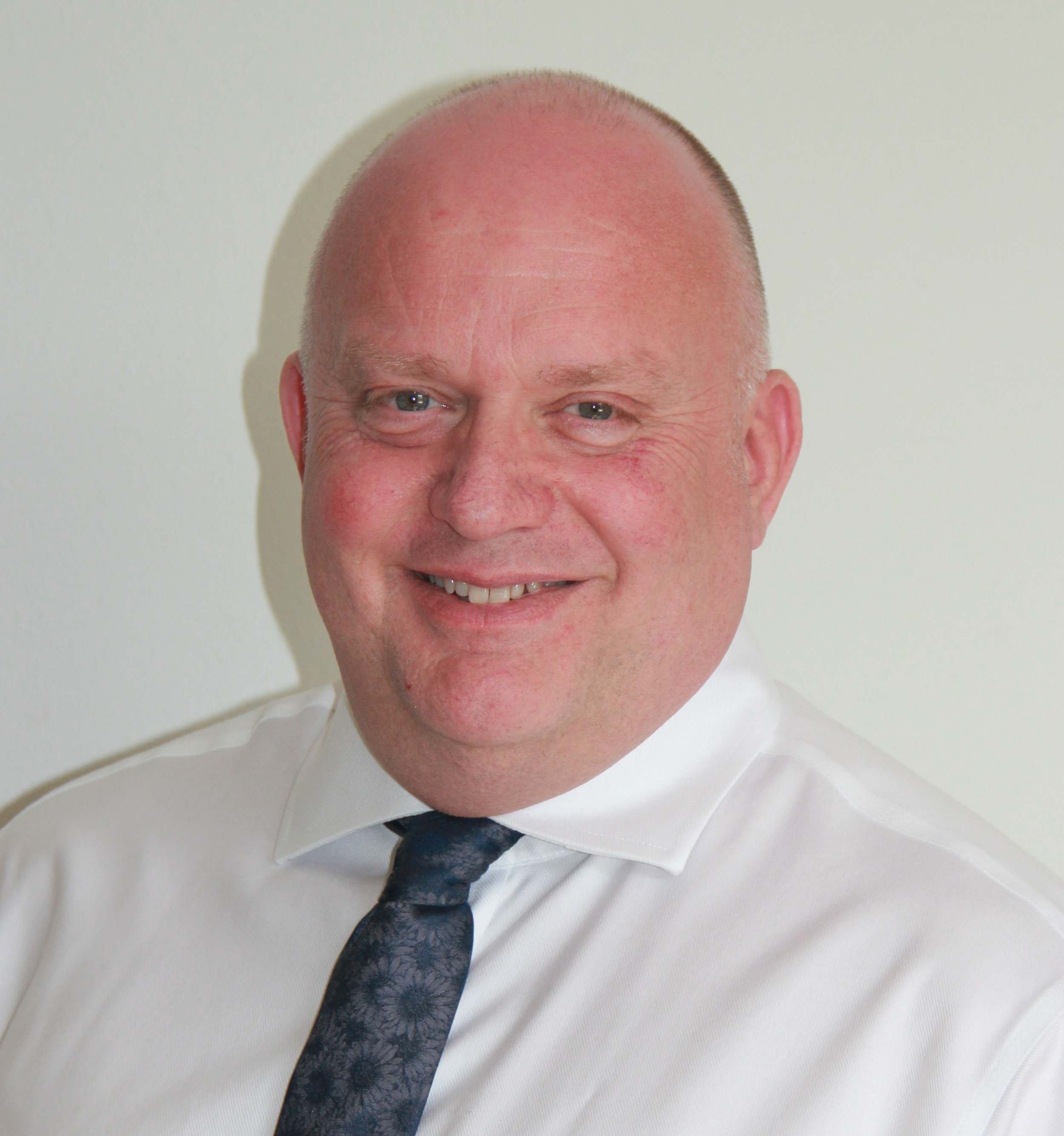man in white shirt and tie smiling
