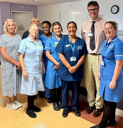People in uniform smiling on a ward