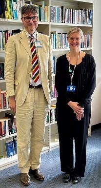 Tall man next to woman smiling
