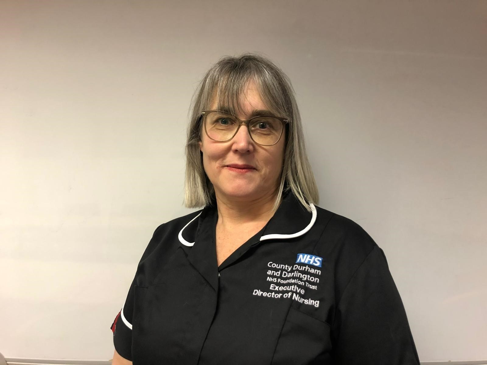 woman in nursing dress smiling