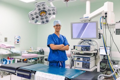 Man in scrubs in theatre smiling