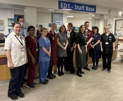People in scrubs smiling in a ward
