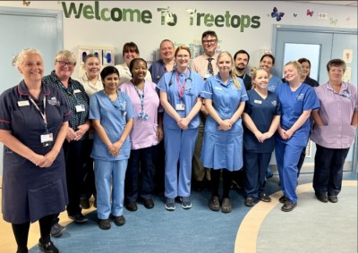 nursing staff in uniform smiling on a ward