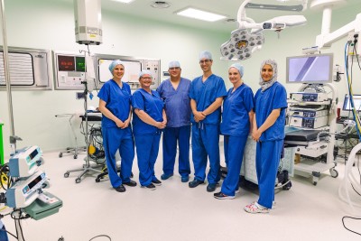 group of staff in scrubs in operating theatre