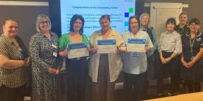 People smiling holding certificates