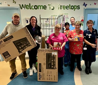People smiling holding boxes