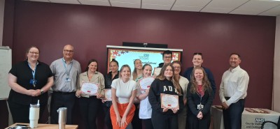 Group of students smiling holding certificates