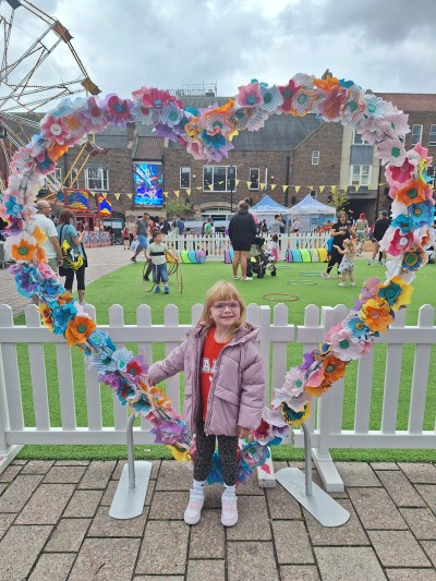 local female child with heart floral installation