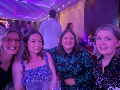 Group of people smiling at a table at an event