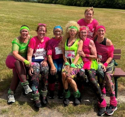 People dressed in pink and muddy outside