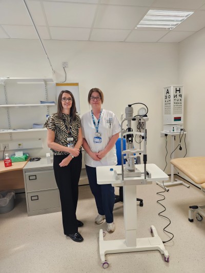 Two people standing next to equipment
