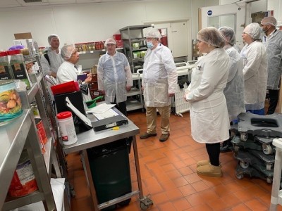 People wearing protective white clothing visiting the kitchens
