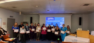 Group of people smiling holding certificates