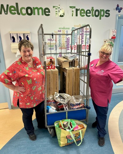 Treetops staff with donated items.jpg