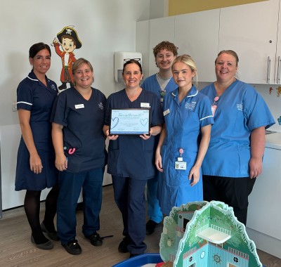 nurses smiling in uniform on a ward
