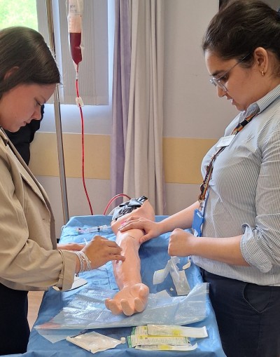 Students practicing on a dummy arm