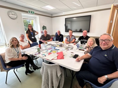People sat round a table smiling