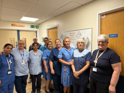 Nursing staff in uniform smiling on a ward