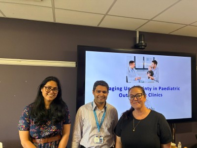 Three people smiling together in a room