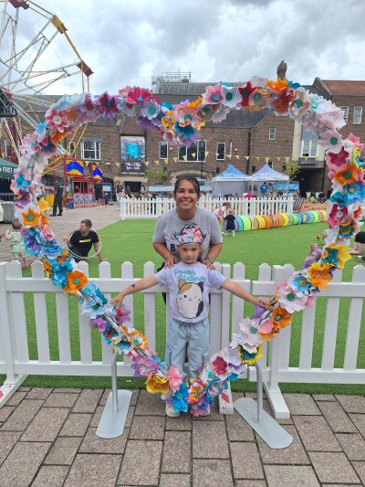 local family with floral heart installation