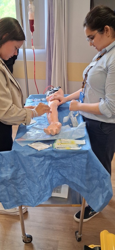 Students practicing on a dummy arm