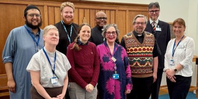 men and women smiling in a chapel